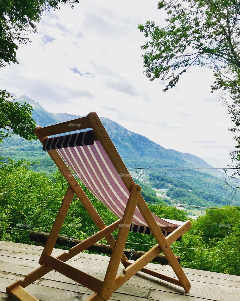 Beautiful view of the mountains, summer chair on the terrace. Tourism, recreation, nature