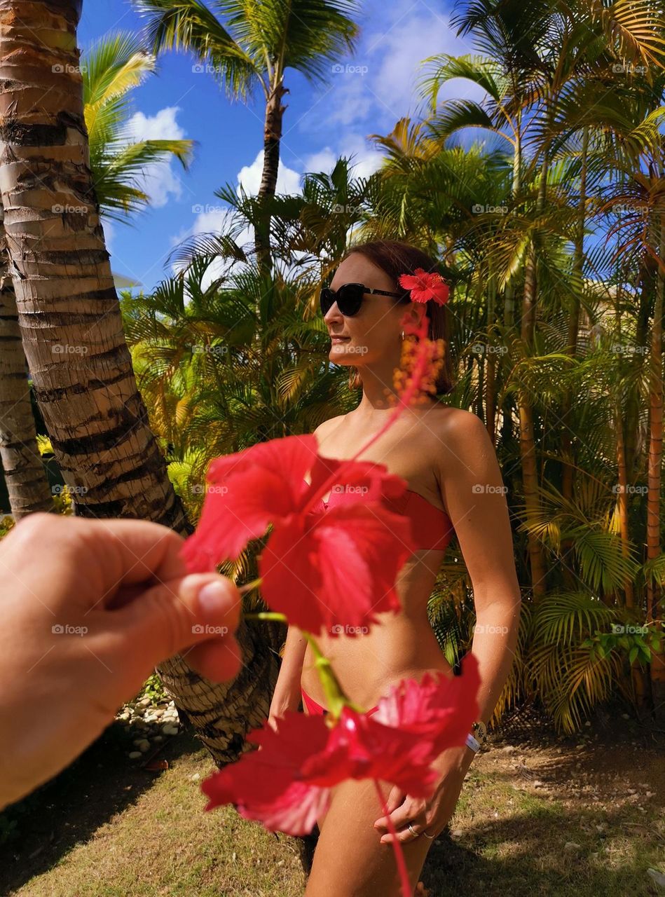 Summer outfit, summer mood, summer time. Red bikini and beautiful flowers.