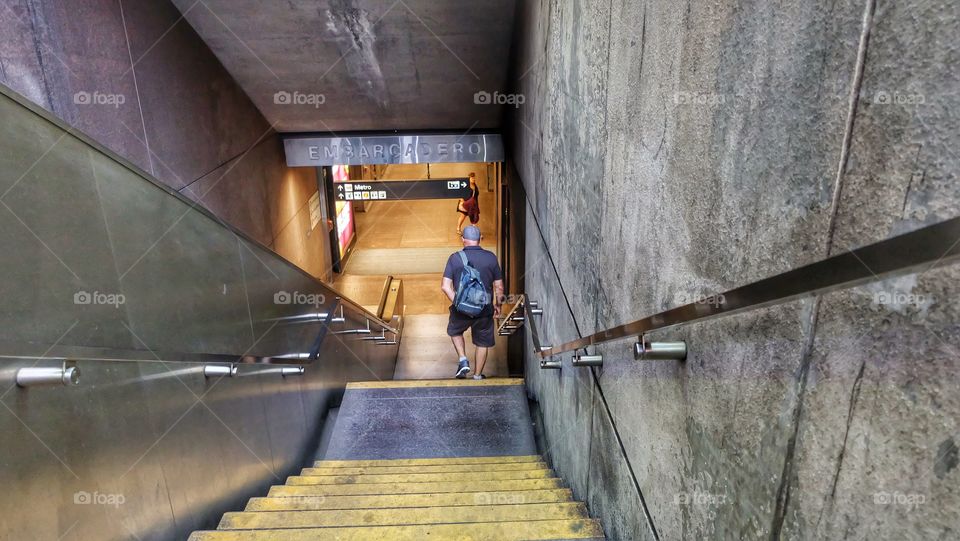A commuter heading to the underground Bart train in San Francisco, CA. 