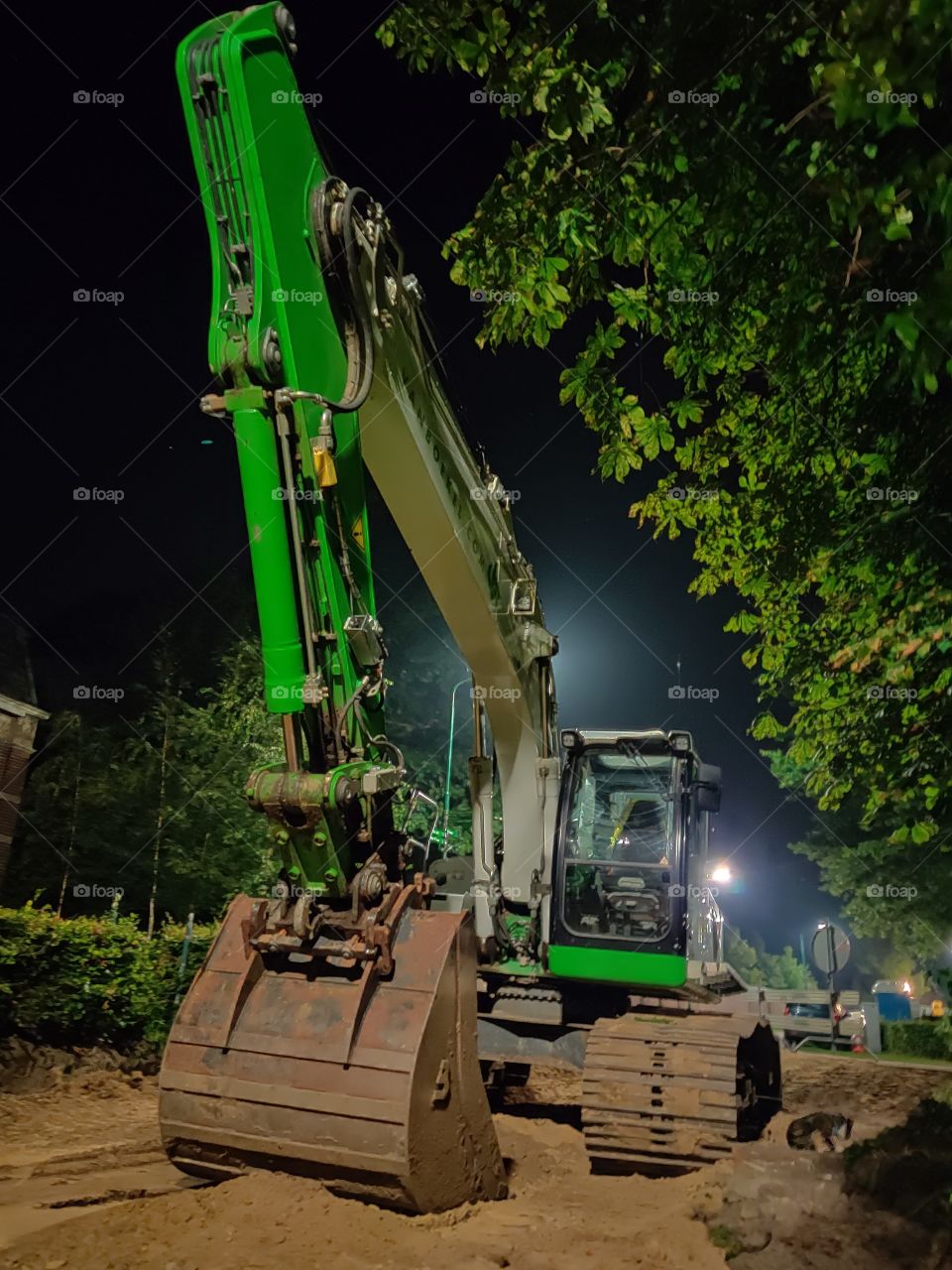 Excavator at night in the sand