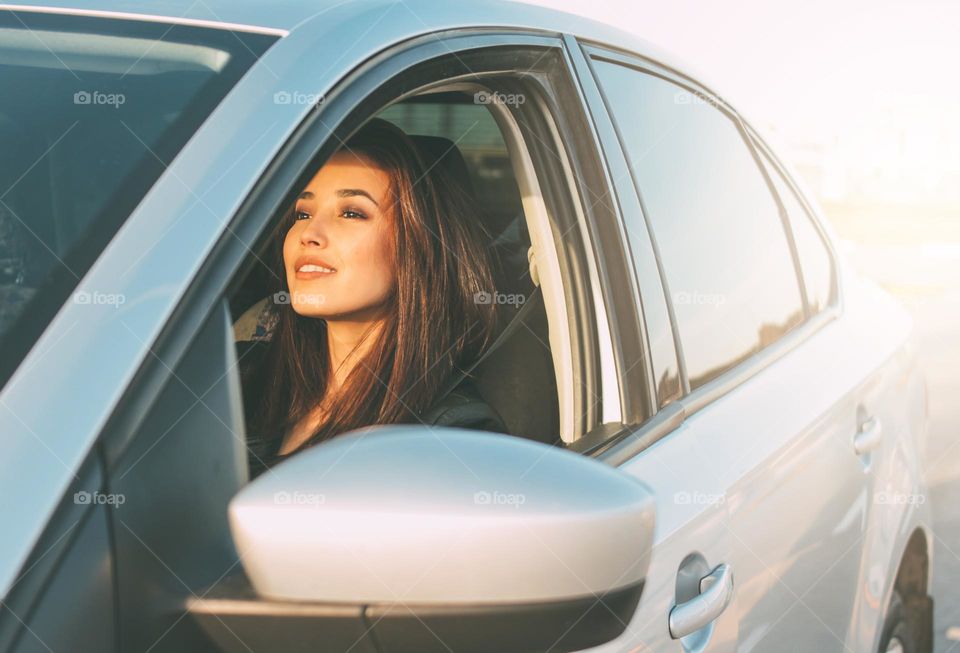 Young brunette long hair woman driving passenger car