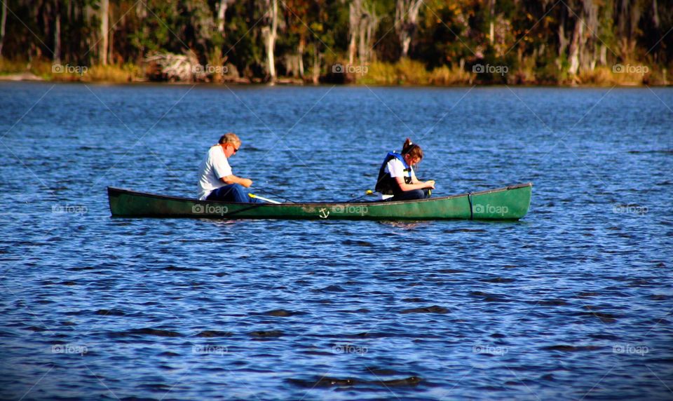 Father and daughter fishing in a canoe