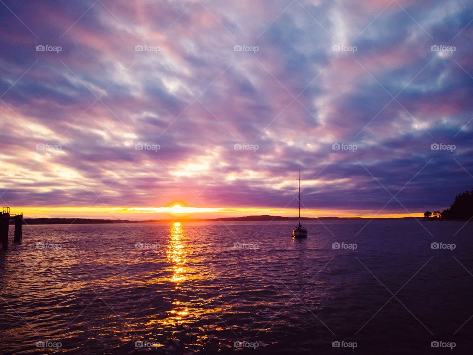 Sail boat silhouette in a purple sunset