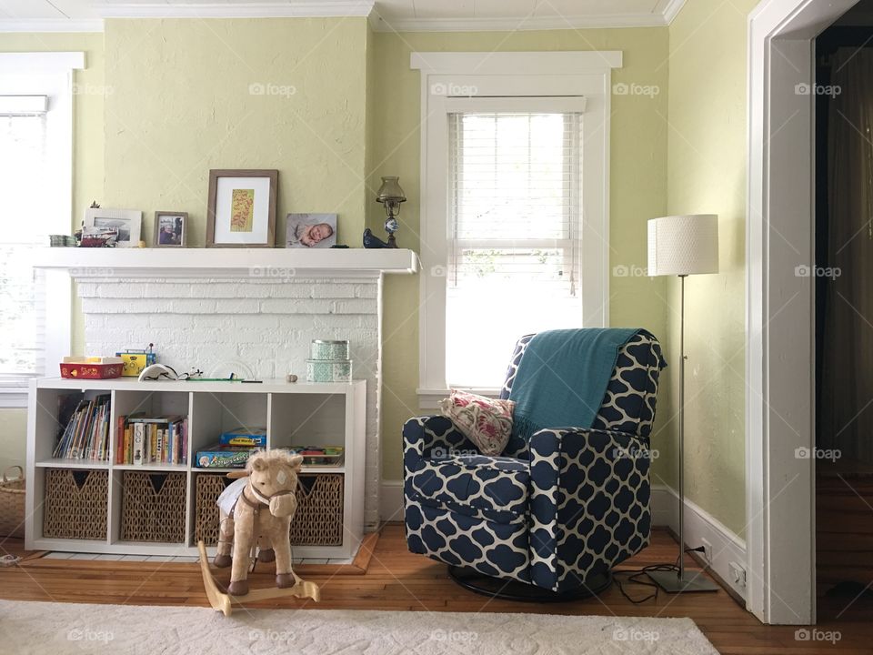 Cozy blue rocking chair in a modern family living room.