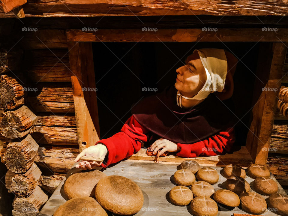 Creepy doll selling fake bread.