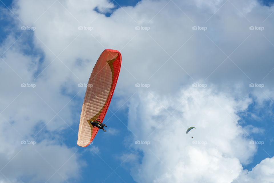 Paraglider on the blue sky