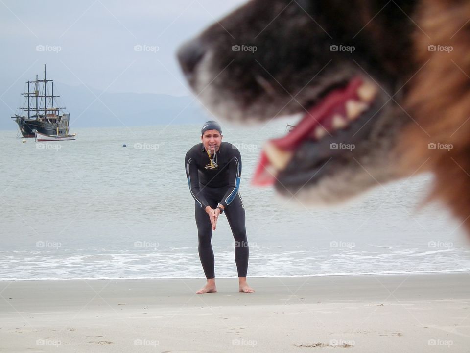 Man in wet suit standing on beach