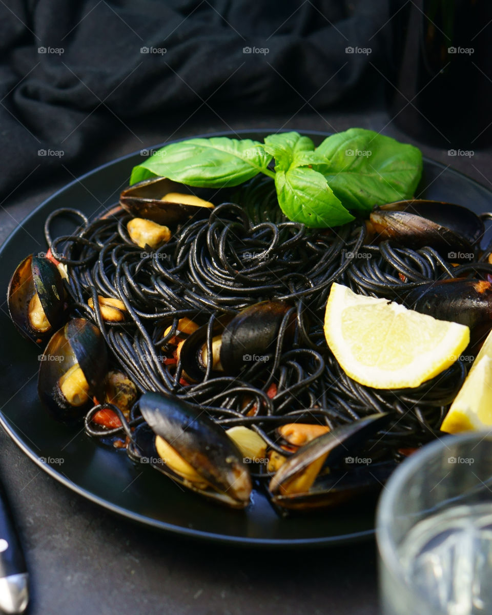 Black spaghetti pasta with clams in plate
