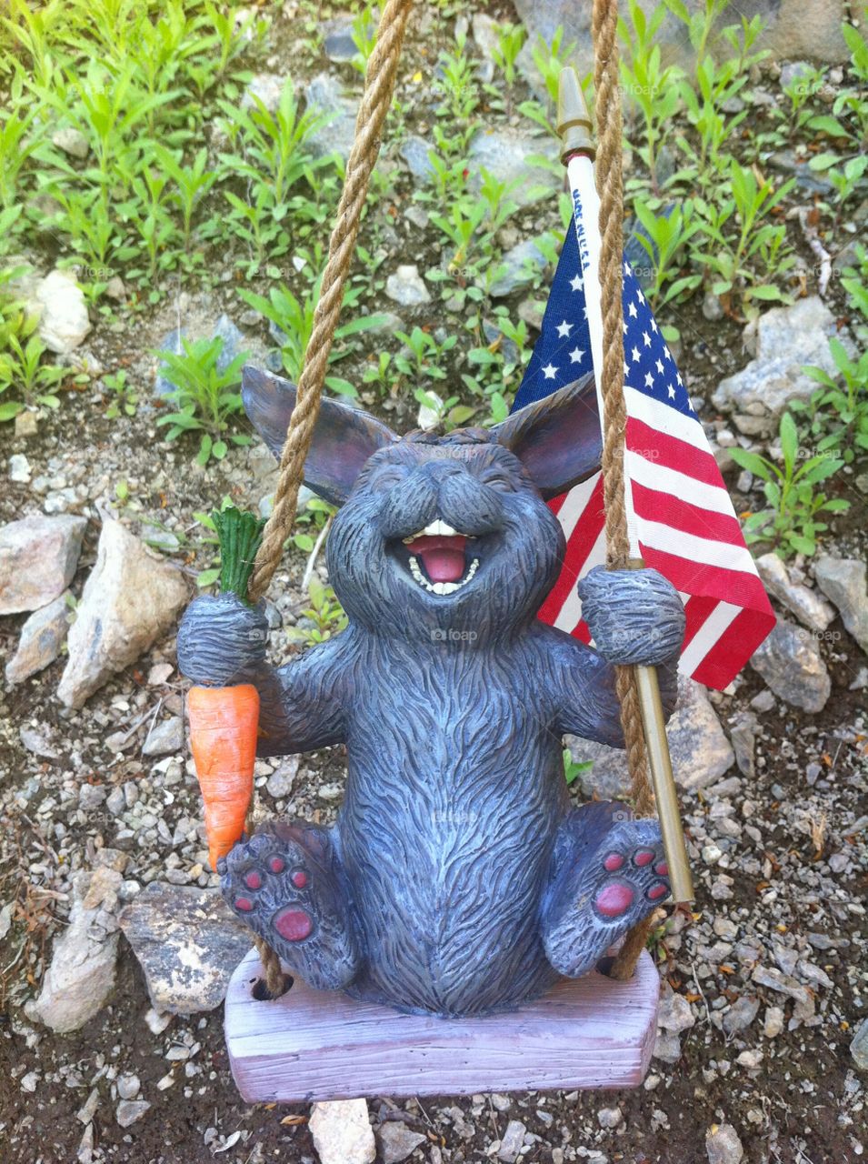 Patriotic Swing. Rabbit waving American flag 