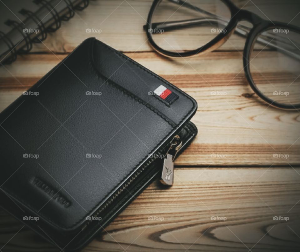 wallet and glasses on the work table