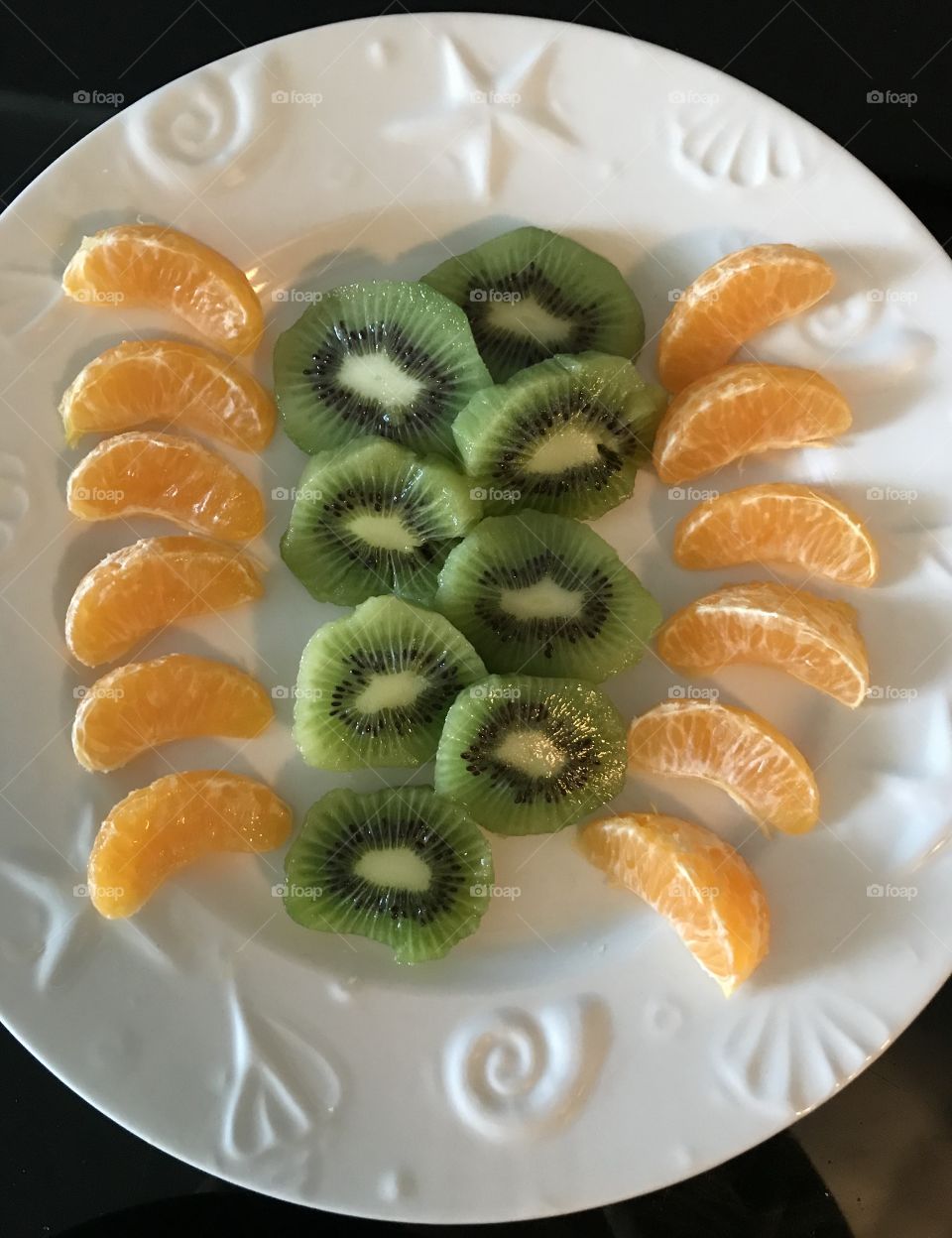 Kiwi and mandarin slices on a plate