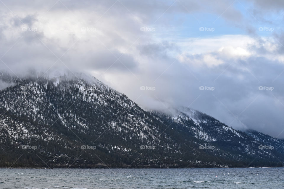 Winter has come. Clouds are rolling over mountains on Lake Tahoe 