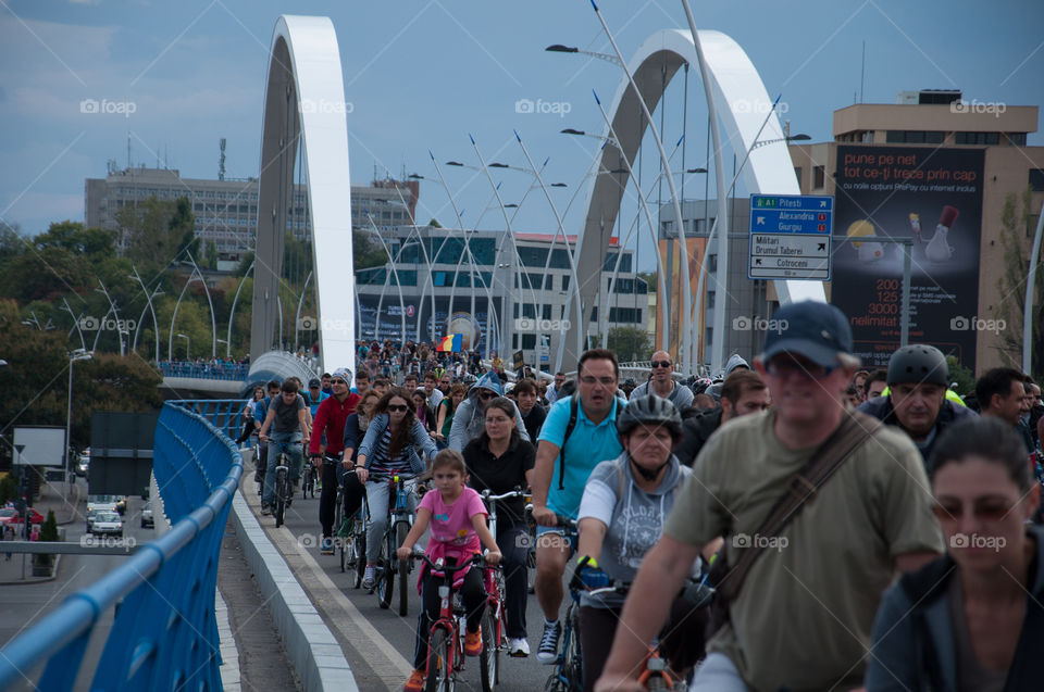 Cycling crowd on a bridge