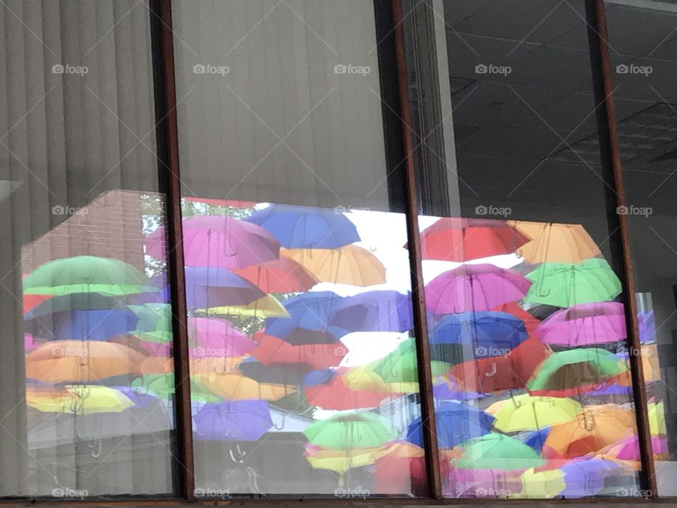 Umbrellas in a reflection on a window 