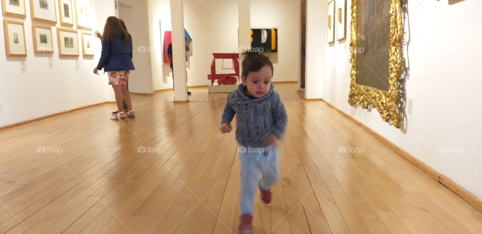 baby running in museum