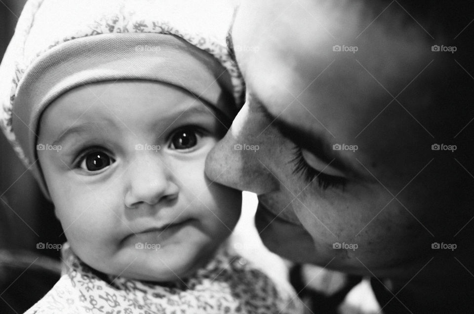 The cute baby with the big eyes cute and her father close up