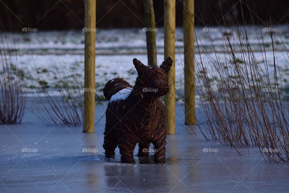 A wooden animal on ice 