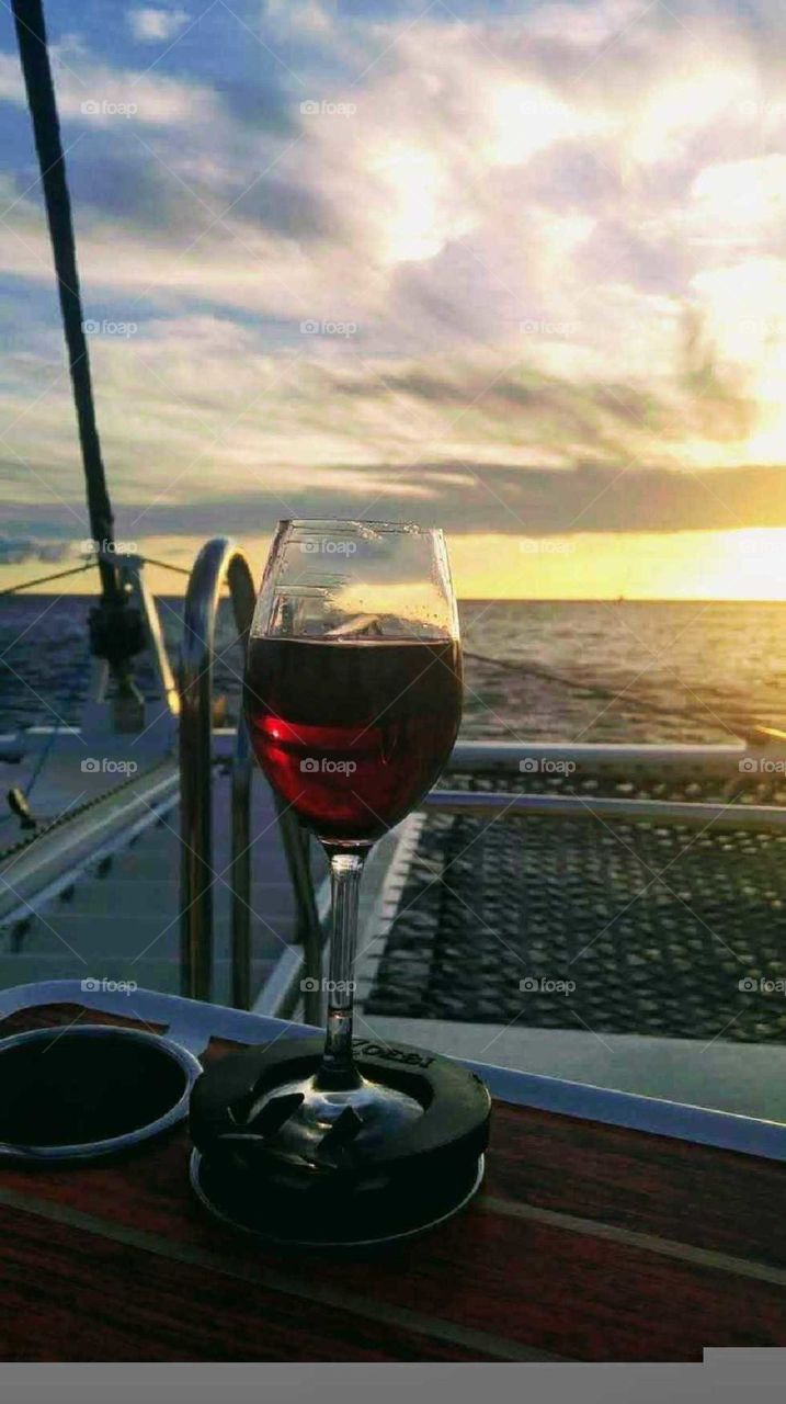 drinking a glass of wine while sailing