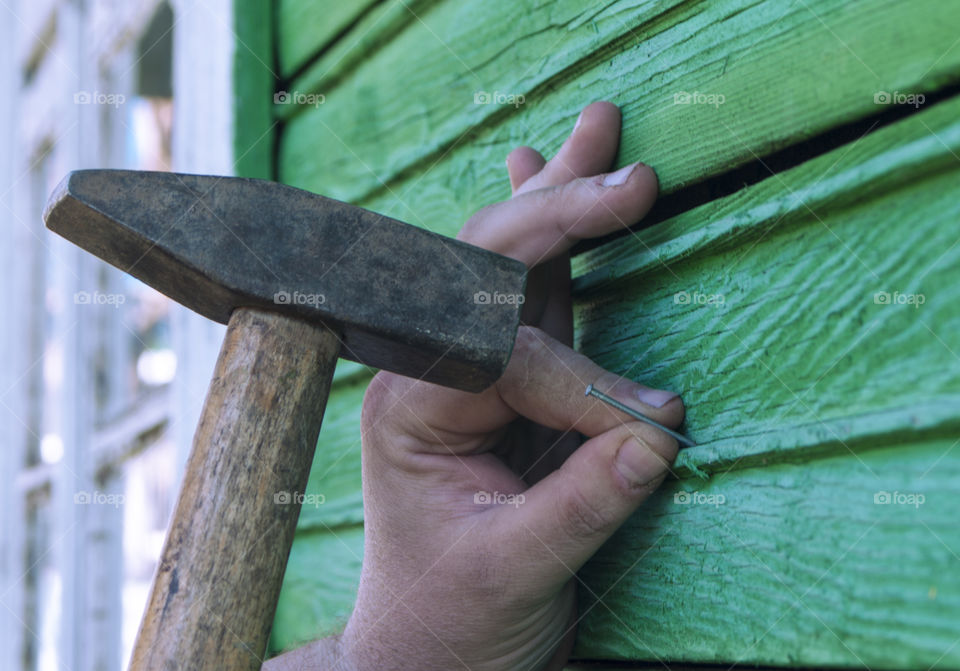 A man hammers a nail