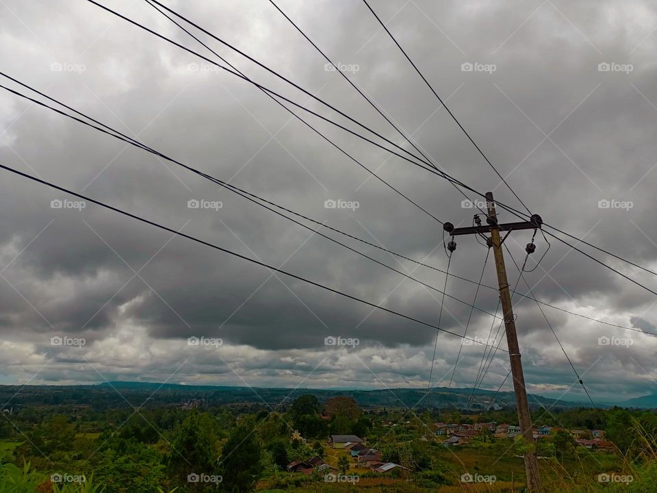 Landscape of mountains, grasslands and electric poles in Doloksanggul District, North Sumatra Province, Indonesia