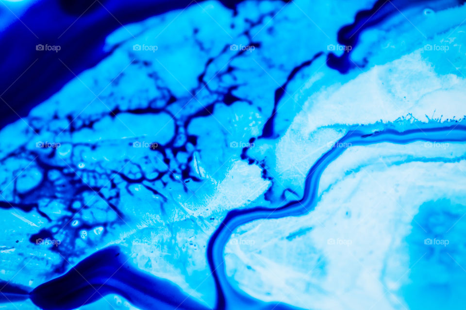 The ink to refill the printer cartridge was spilled onto the white washbasin and the paints blended into abstract drips and patterns.