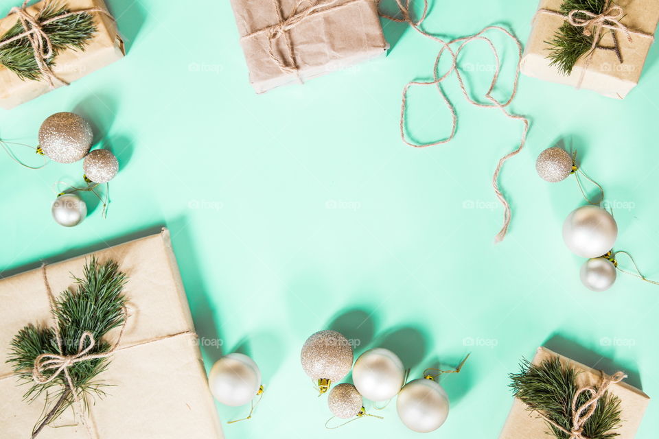 Christmas gift lying on green background. Flatlay items. Flat lay, top view, surprise, happy new year, merry, tree, packing, packed, wrapping, celebrating, holidays, winter, nobody, background 