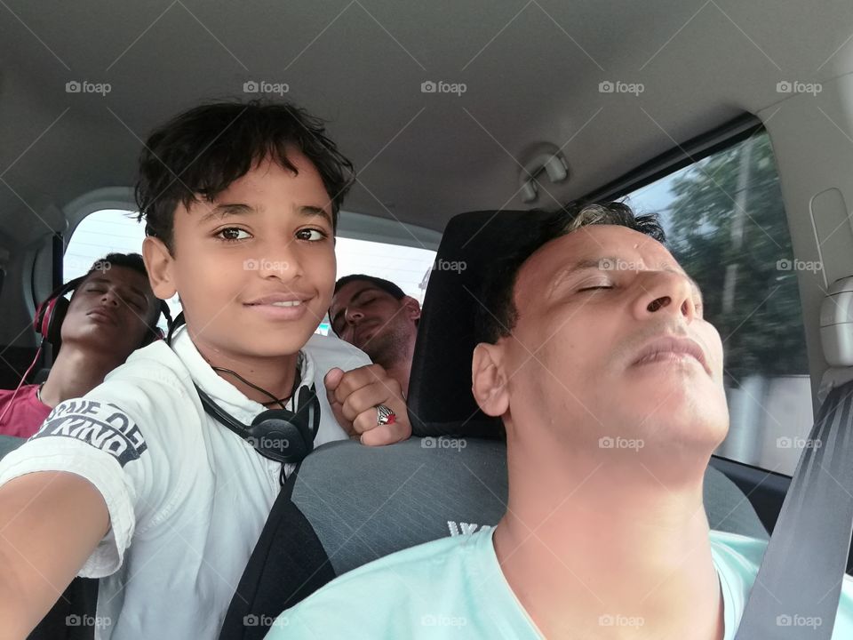 Portrait of a asian boy sitting in car