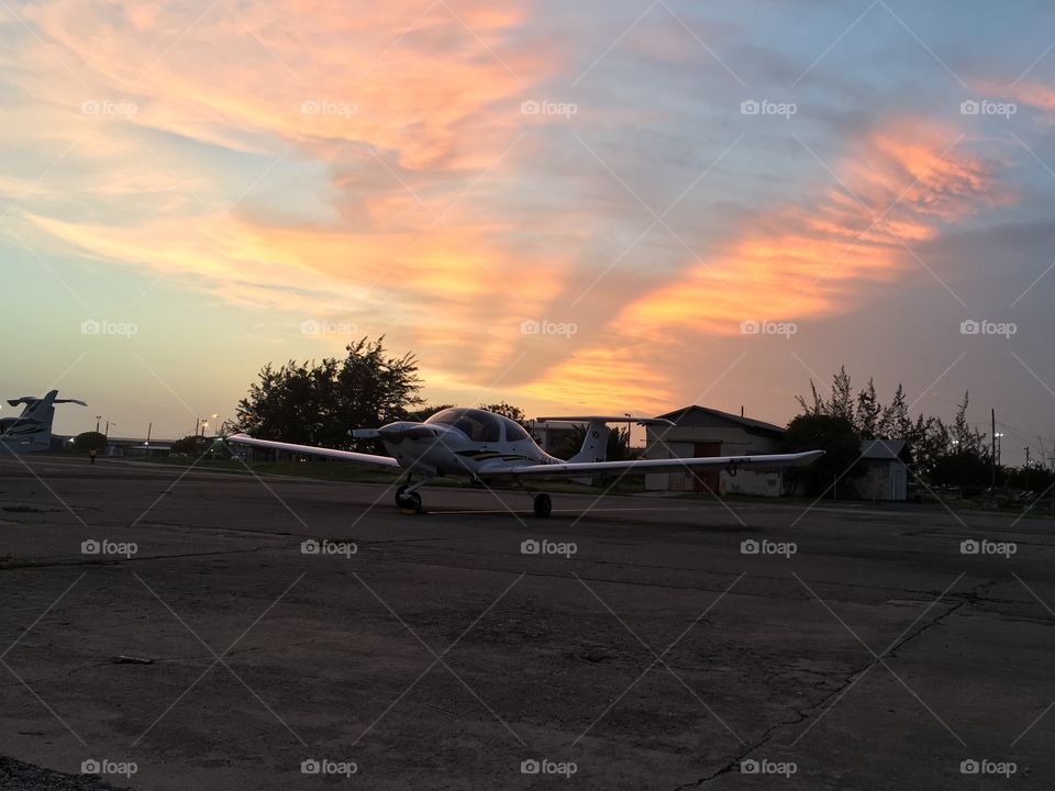 Sunset at Norman Manley International Airport, Kingston Jamaica . One of the Jamaican military planes can be seen sitting on the ramp 