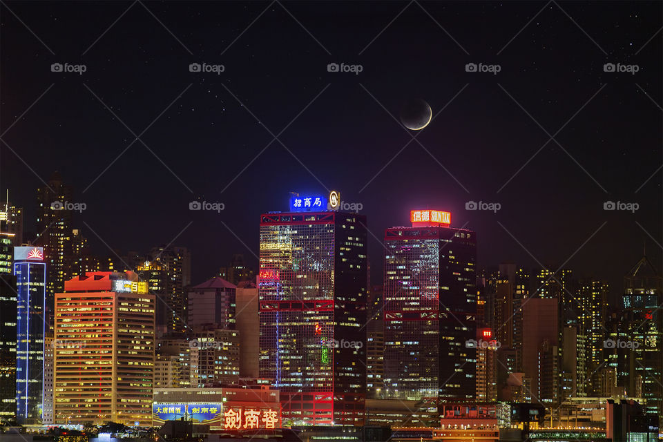 Moonset over Sheung Wan. The new moon sets over Hong Kong's iconic skyline 