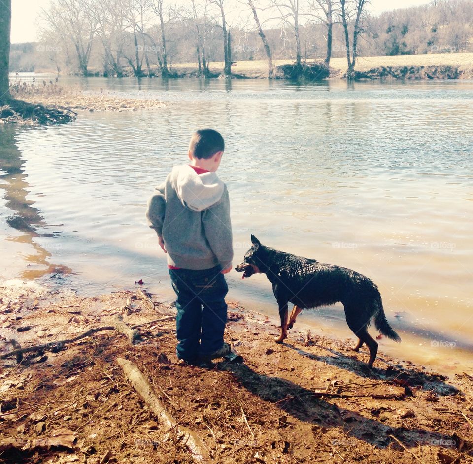 A Boy and His Dog. Boy and dog down by the river