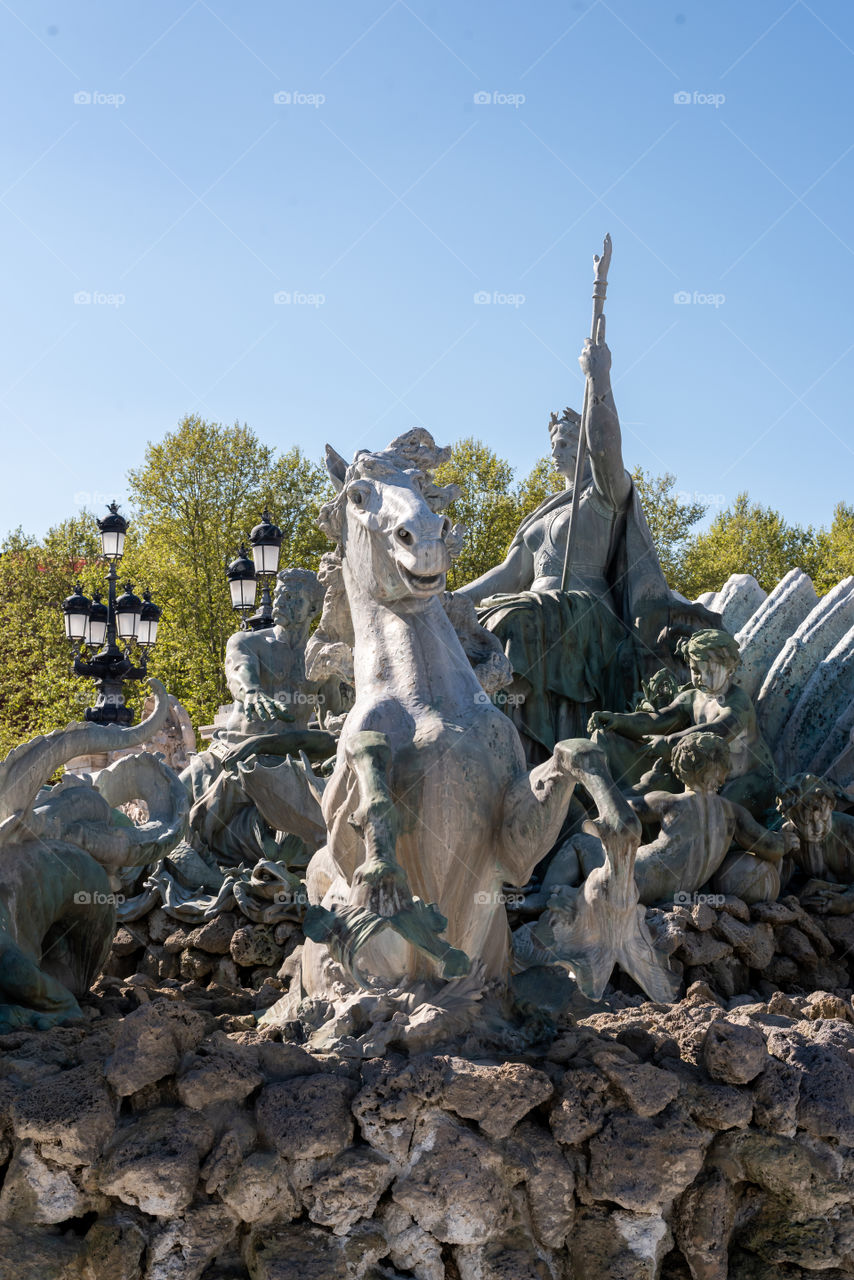 Statue of Poseidon in a fountain of the Quinconces in Bordeaux 