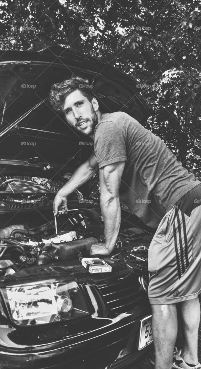 A man cleaning car engine