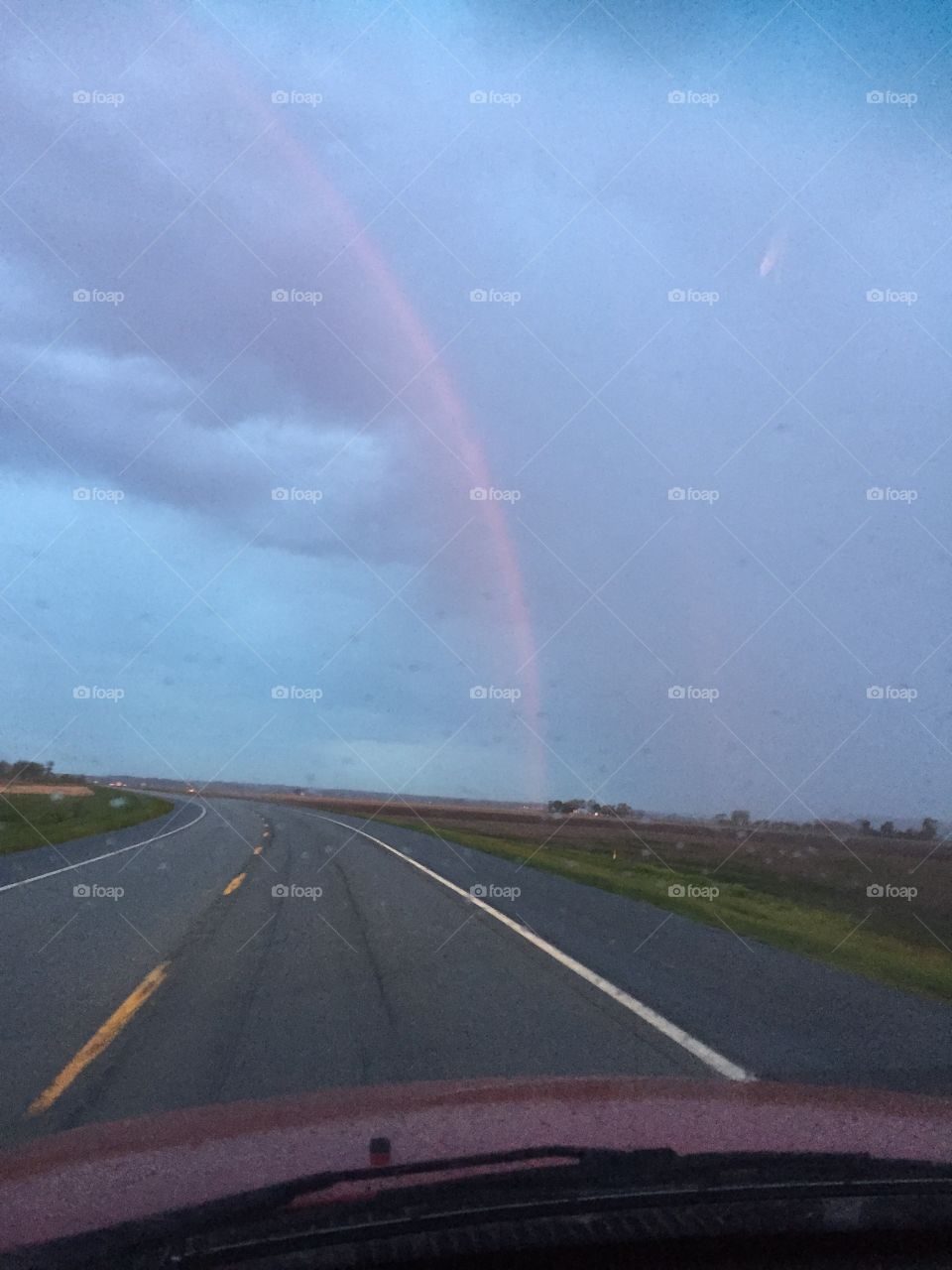 Rainbow Over the Road. This photo was taken early in the morning, after driving through a harsh storm. It was a beautiful sight to see after driving through the wind.