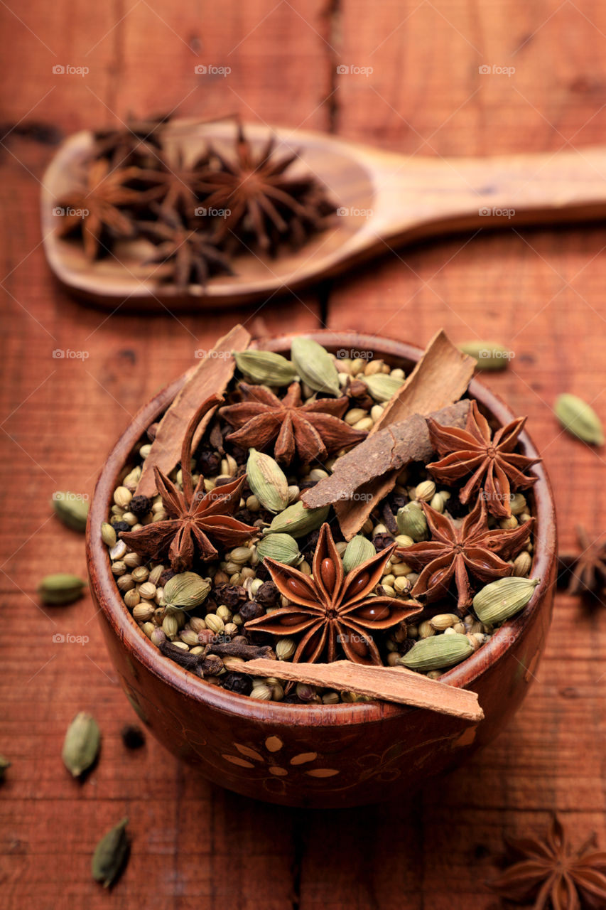 Indian spices on a wooden background