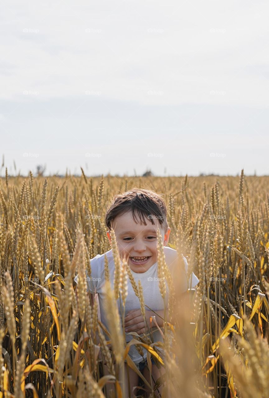 child and mother in wheat field