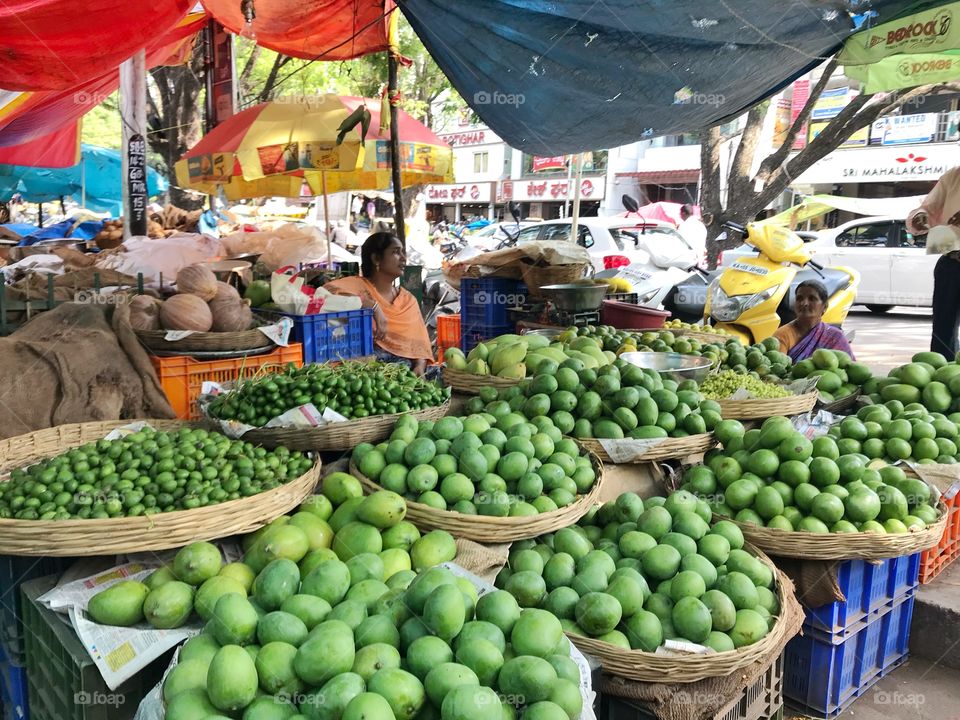 Green mangoes in outdoor market in Bengaluru, Karnataka, India 