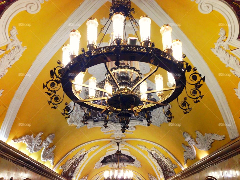 Soviet huge lamp and colorful mosaic on the yellow ceiling in Moscow, Russia