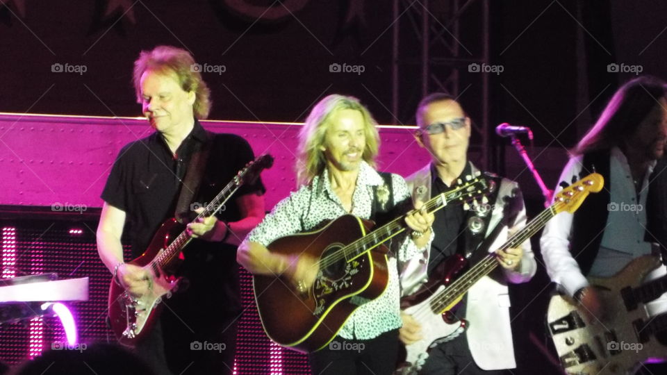 Group of caucasian performing on stage in concert