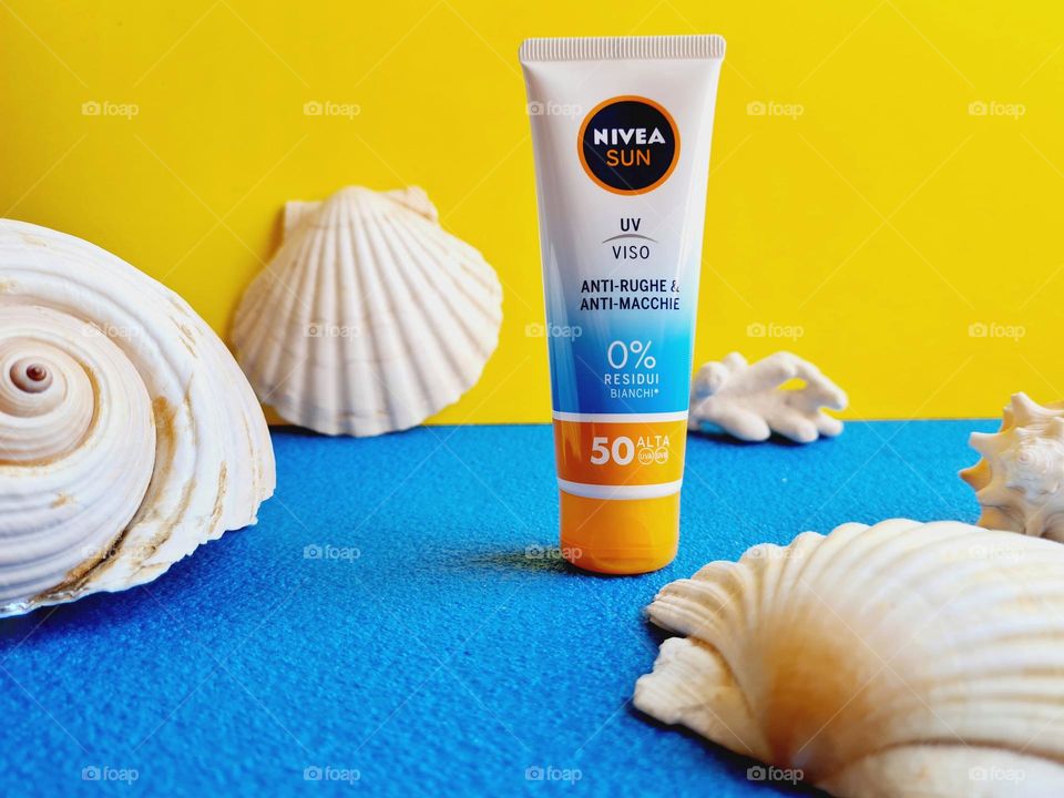 Nivea Sun sunscreen in the foreground surrounded by sea shells