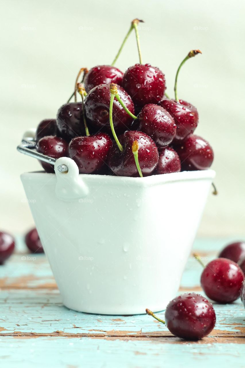 Fresh cherries in a white vase