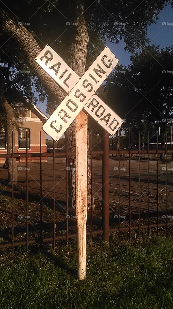 rail road cross. This is a sign posted up as a decorative marker in front of the hangout spot for the local high school