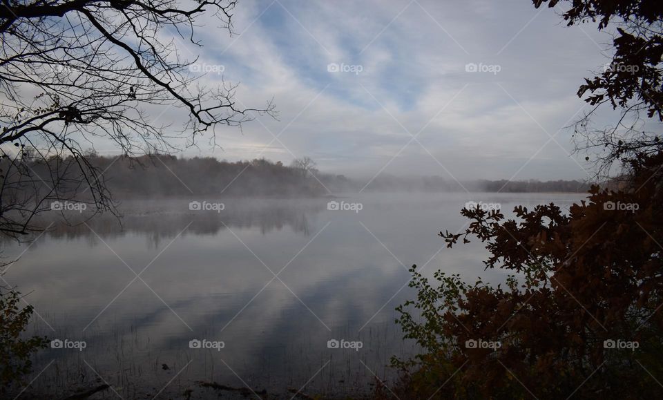 The clouds reflecting off the foggy lake