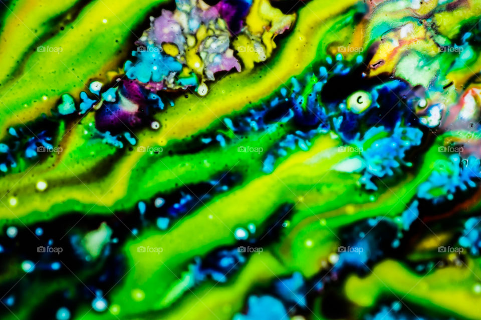 The ink to refill the printer cartridge was spilled onto the white washbasin and the paints blended into abstract drips and patterns.