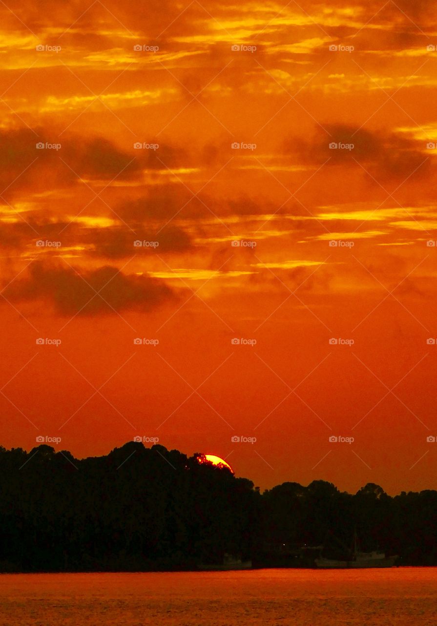 Radiating sun descends below the horizon! Capturing beautiful sunset reflections is not easy. It takes planning, creativity and sometimes luck. Many times the shot is one-in-a-million. By using water, mirrors or any sort of reflective surface, you can change an image into a work of art! This is my interpretation of stunning and incredible sunset reflection photo!
Exhale and take it all in!