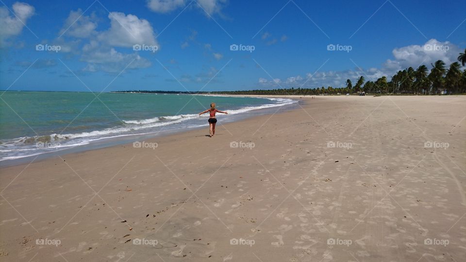 Woman walking in the Porto de Gallinas beach. Brazil 