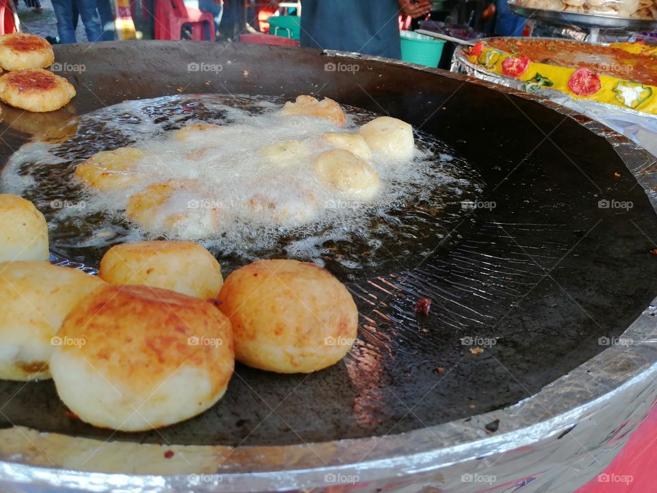 Aloo  tikki or potato tikki chaat also called Indian  street snacks 
Frying Aloo or potato with hot oil in street stall and fried these potato and lead to making of Aloo  tikki.