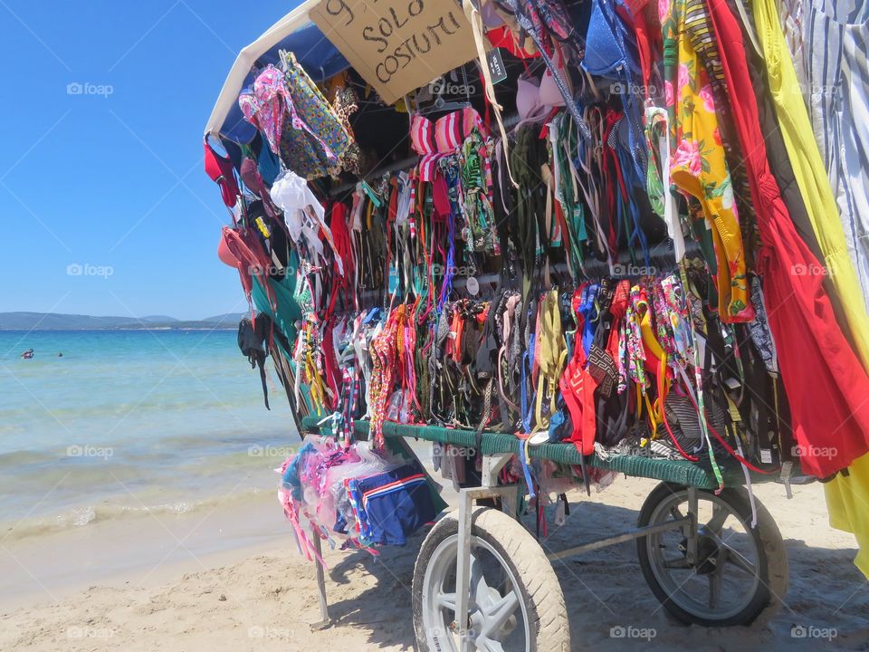 swimsuit mobile shop in front of mediterranean sea. Sardinia - Italy