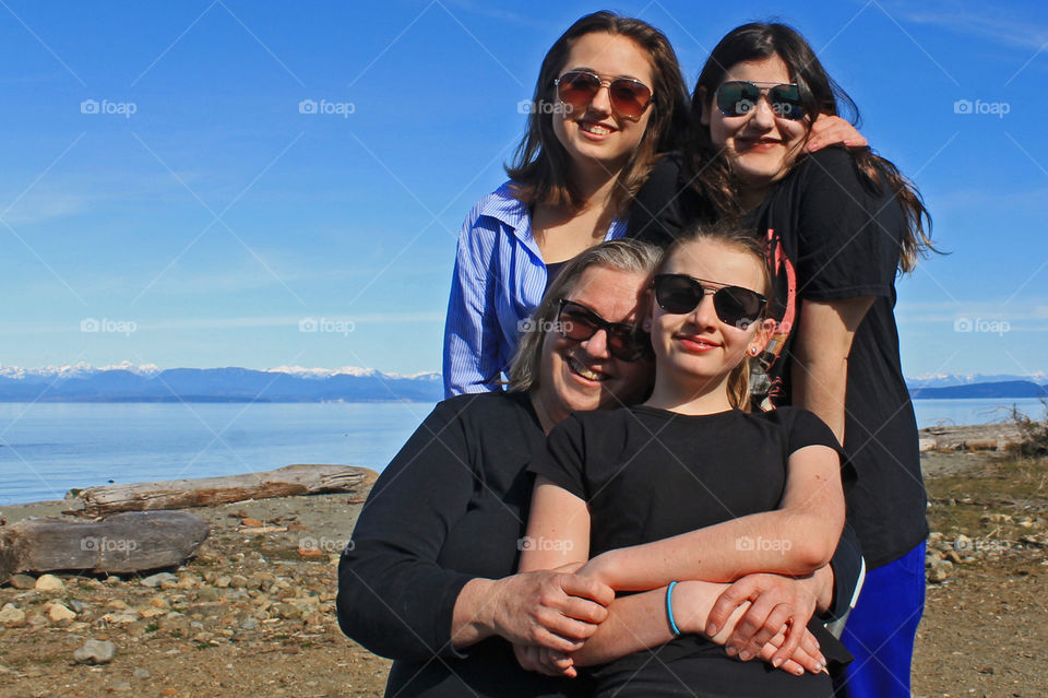 Nothing in this world makes me as happy as my family! This photo of me & my 3 beautiful daughters snuggling was taken at one of our favourite beaches on a beautiful sunny March afternoon. The background is beach, ocean &  coastal mountains! ❤️