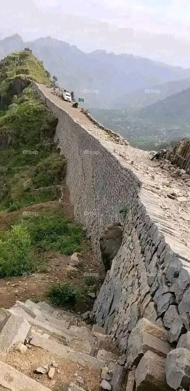 A stunning view of green mountains covered in fog in Yemen