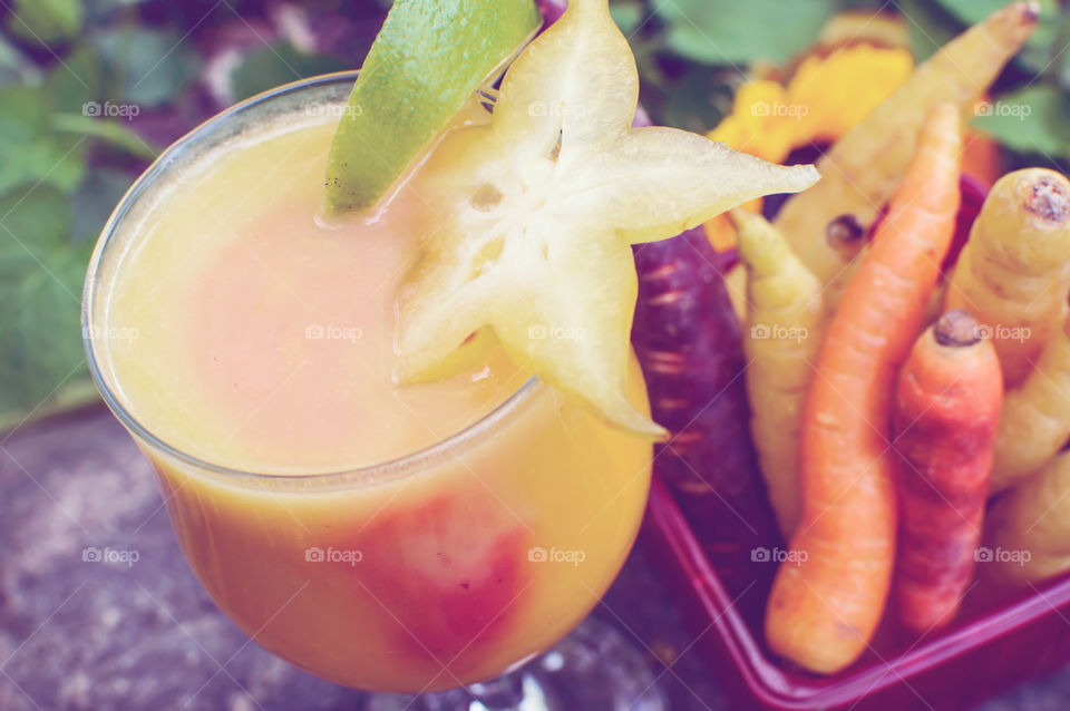 Fresh white fruit smoothie with colorful summer berry and carrot infusion technique conceptual healthy lifestyle smoothie photography background 